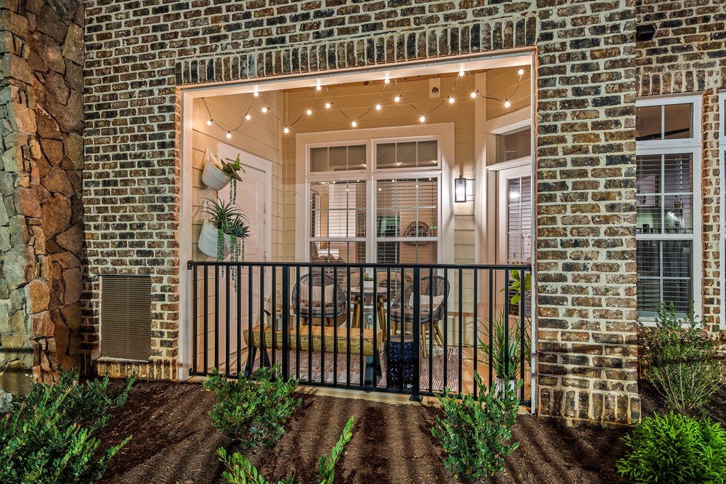 a porch with a table and chairs on it