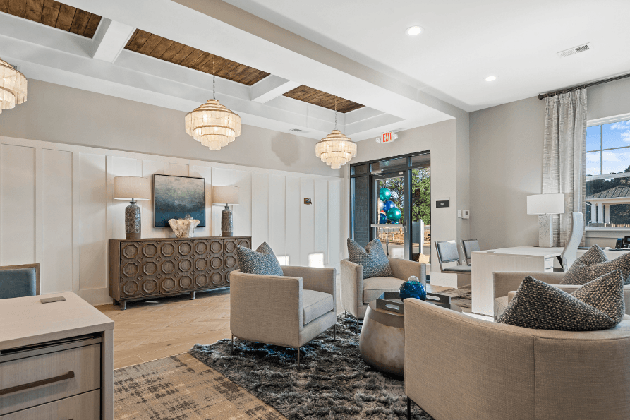a living room with couches and chairs and a table