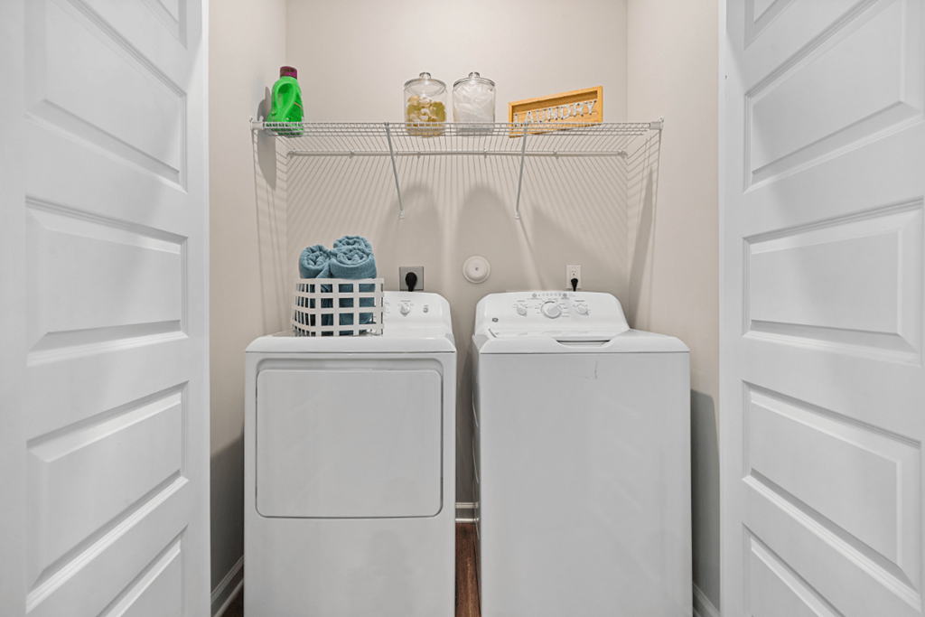 a small laundry room with two washes and a dryer