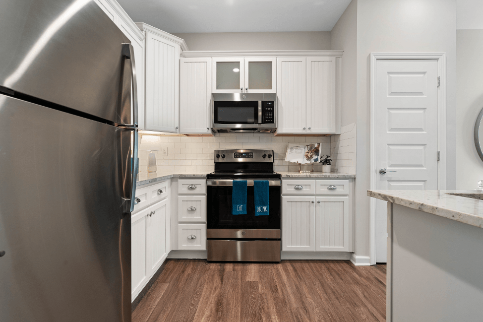 a kitchen with stainless steel appliances and white cabinets