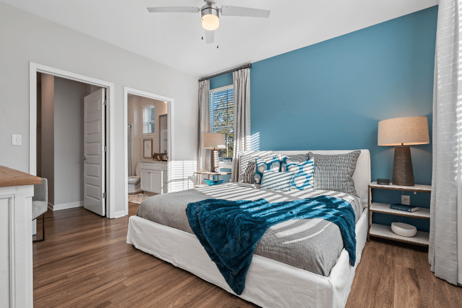Home Interior a bedroom with a large bed and a bathroom