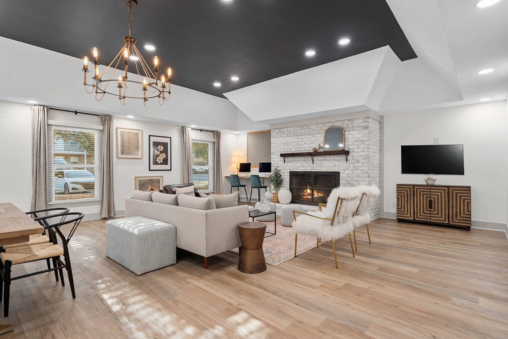 a living room with couches and chairs and a fireplace