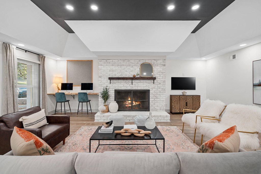 a living room with couches and a table and a fireplace