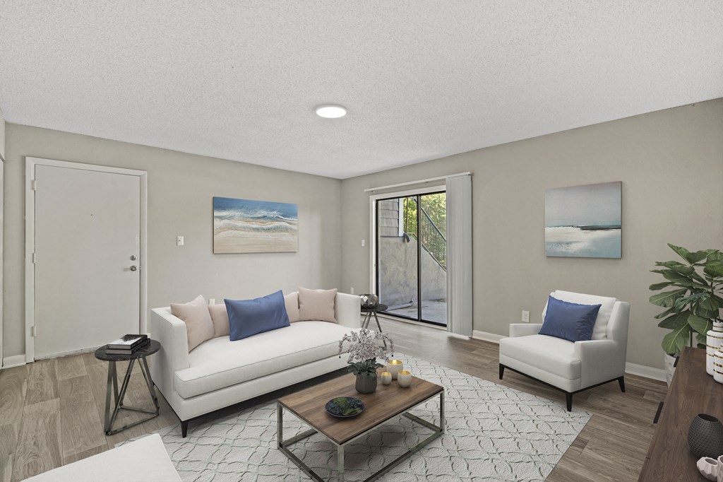 a living room with a white couch and two white chairs