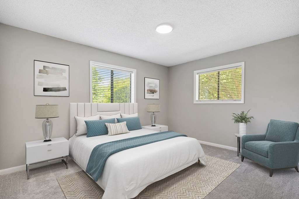 a bedroom with a bed and a chair in a 555 waverly unit