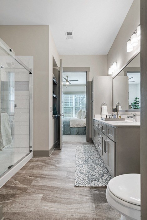 a bathroom with a shower and a sink and a toilet