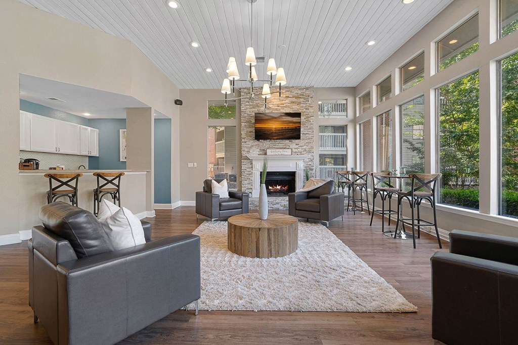 a living room with couches and chairs and a fireplace