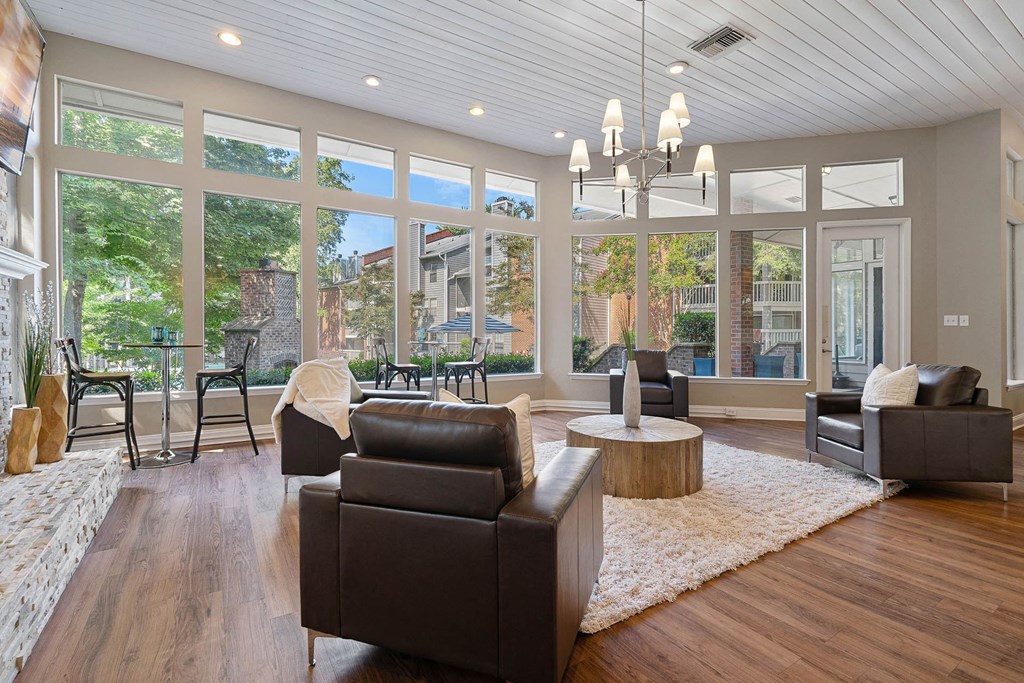 a living room with leather furniture and large windows