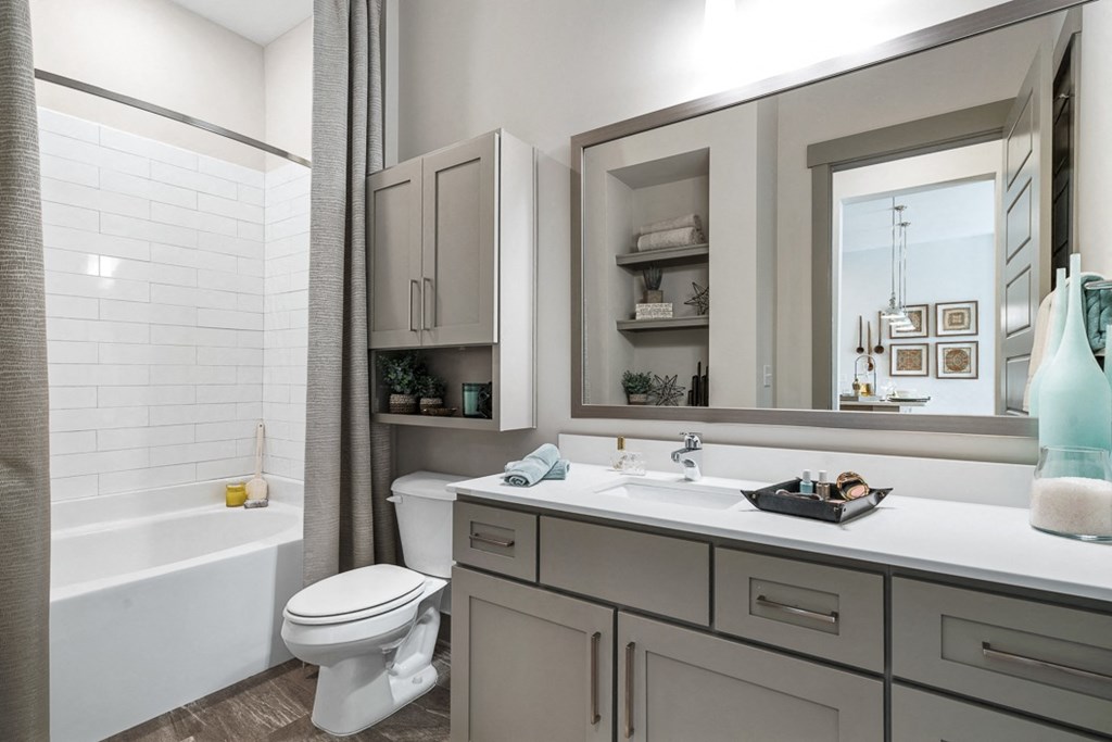 a bathroom with a sink and a toilet and a bath tub