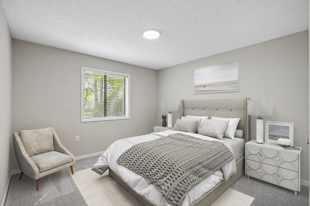 a bedroom with a bed and a chair