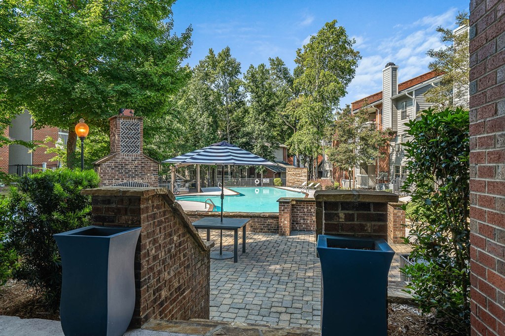 a backyard with a swimming pool and umbrellas