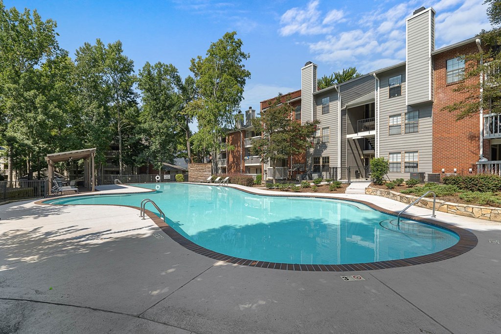 a swimming pool with a building in the background