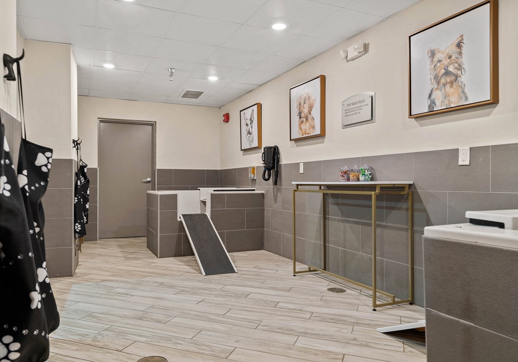 a restroom with a urinal and a sink in a building with tiled floors