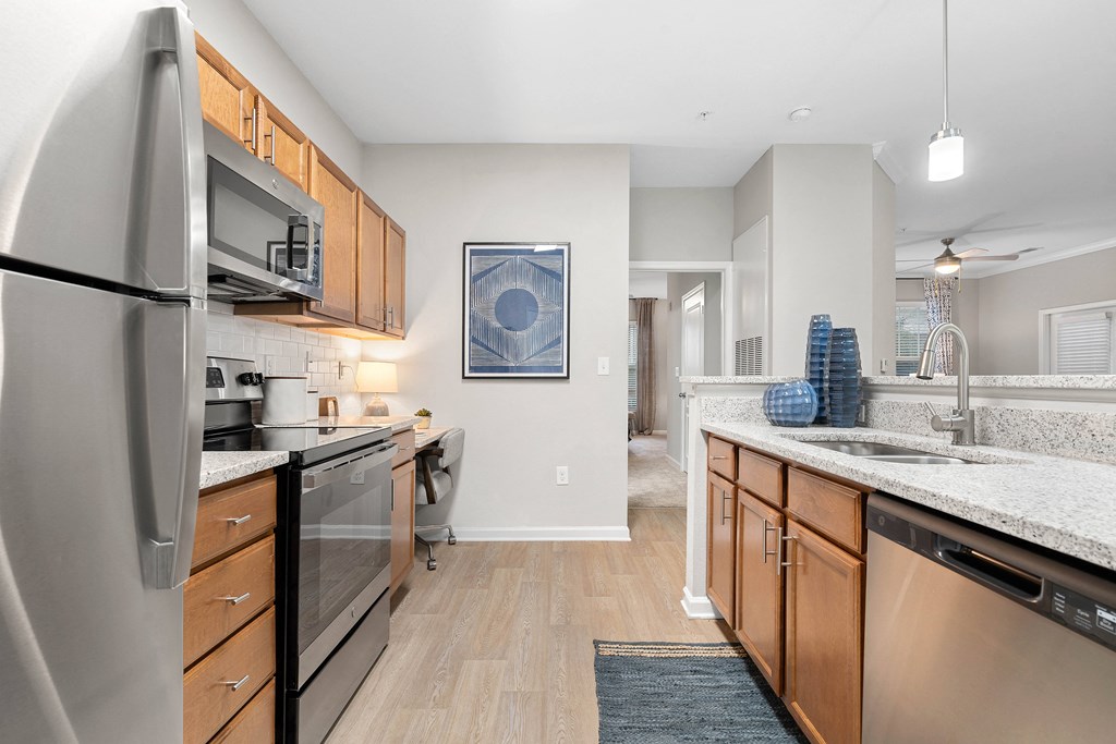 a kitchen with stainless steel appliances and granite counter tops