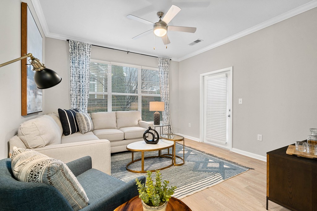 a living room with a couch and a ceiling fan