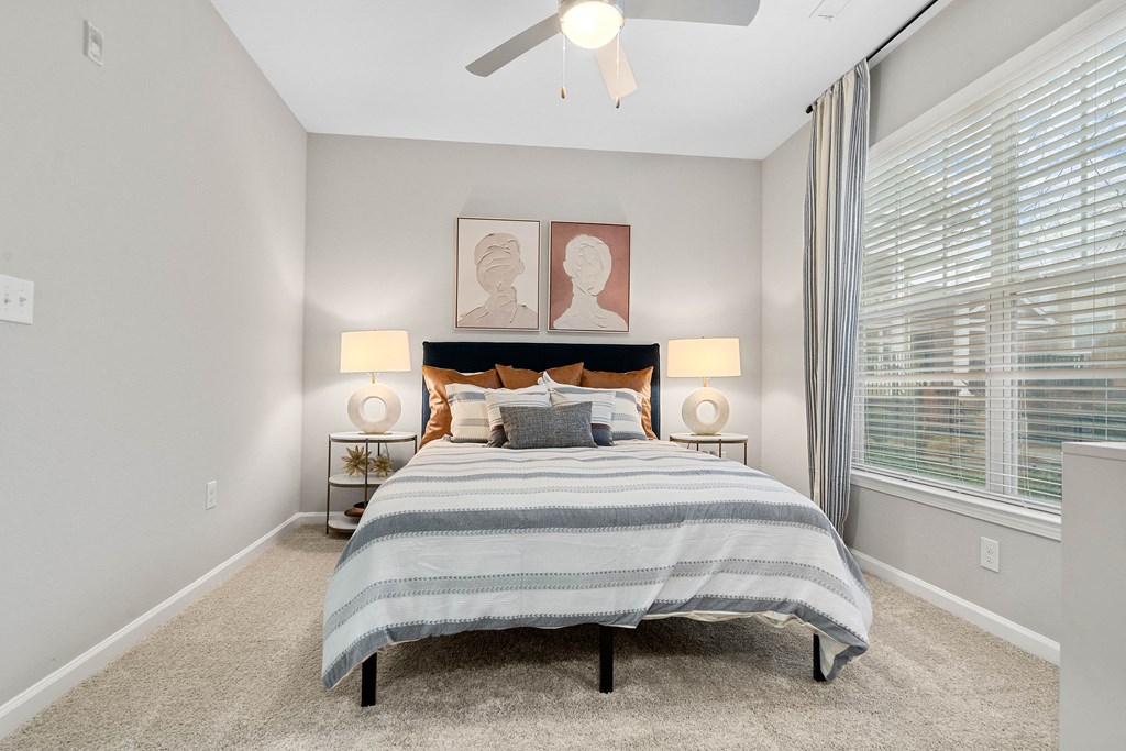 the choices apartments bedroom with ceiling fan and large window