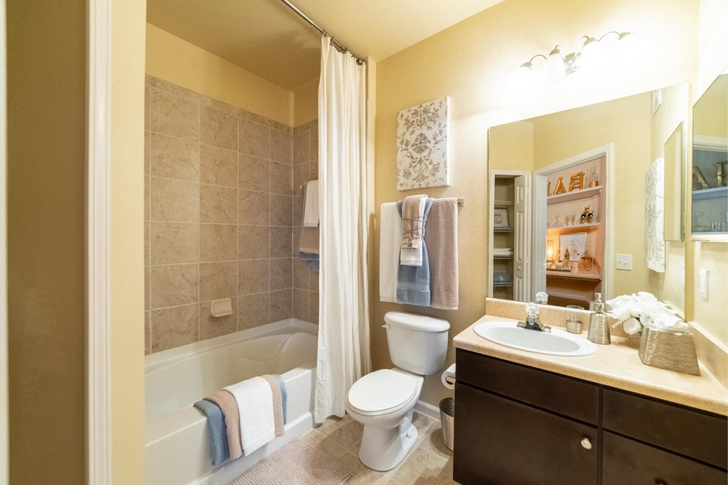 a bathroom with a toilet sink and tub and a shower