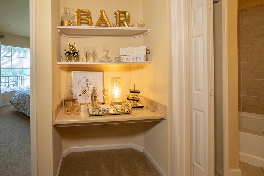 a bathroom with a vanity and shelves with gold letters
