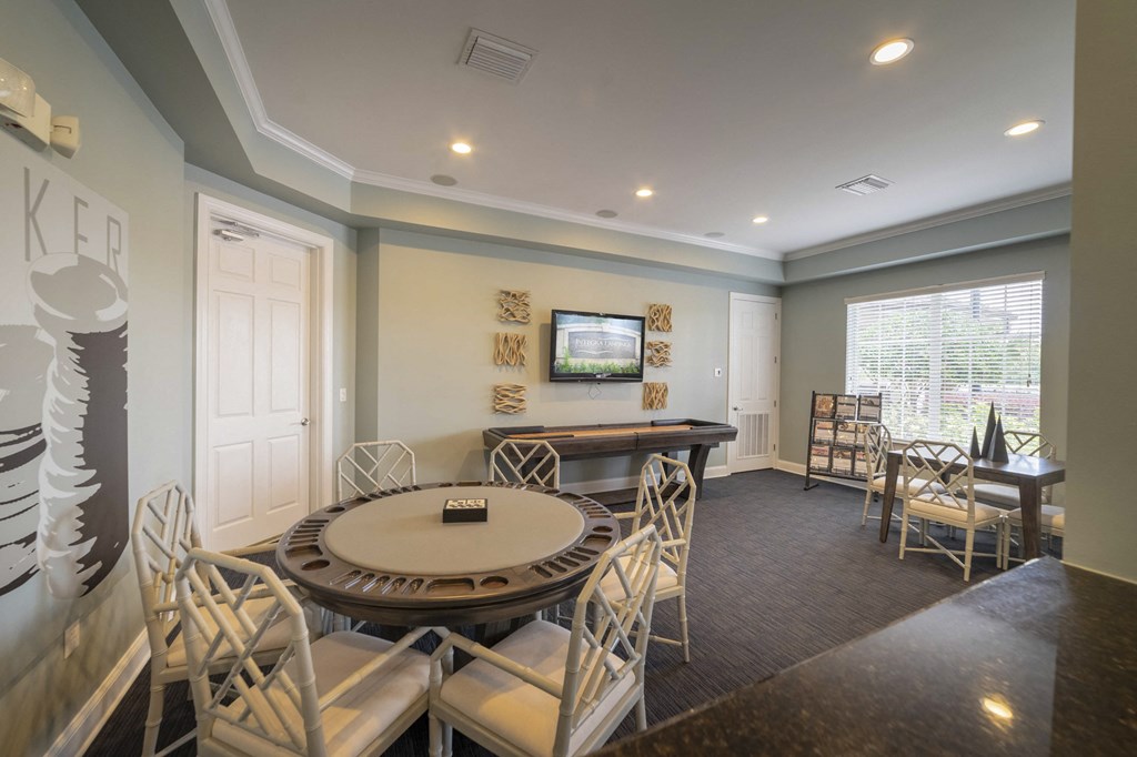 a conference room with a round table and chairs and a piano