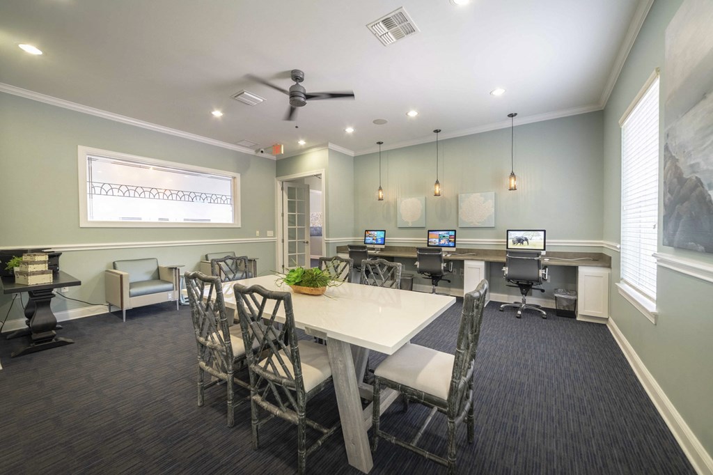 an empty conference room with tables and chairs and computers