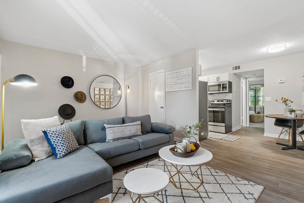 a living room with a blue couch and a coffee table