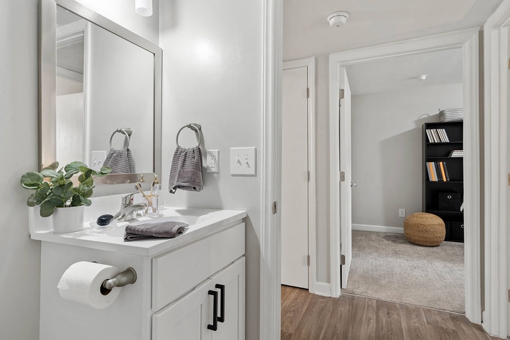 a white bathroom with a sink and a mirror