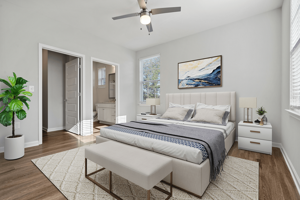 a white bedroom with a bed and a ceiling fan