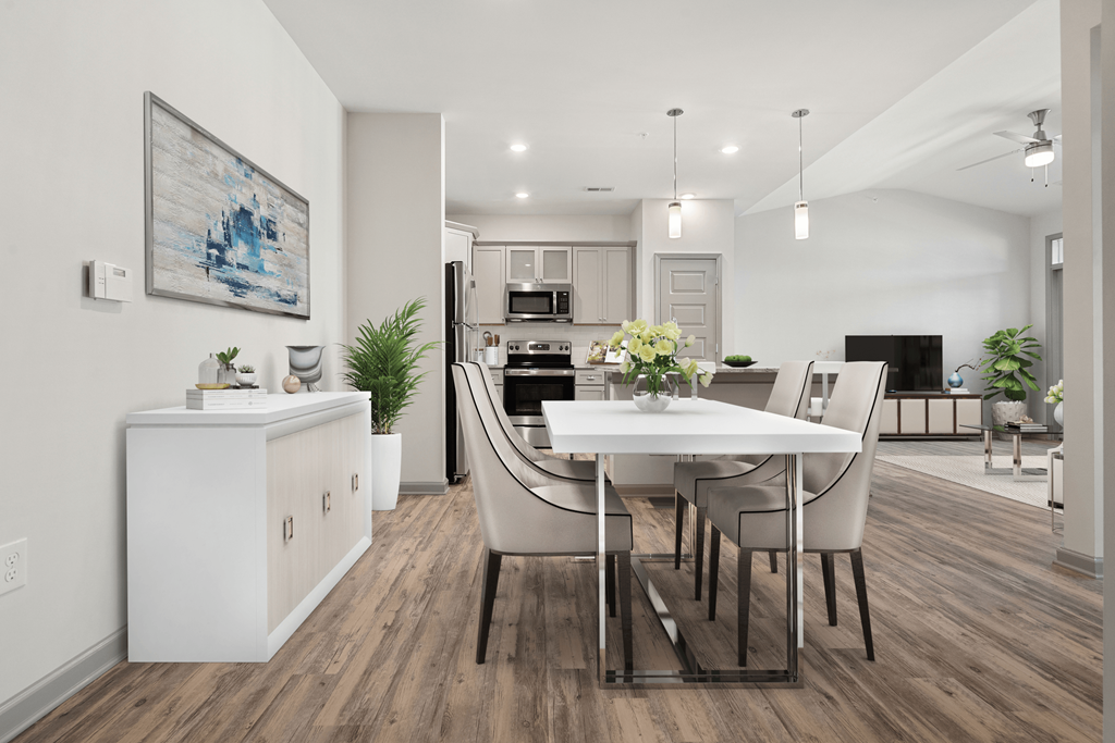 a living room and dining room with a table and chairs