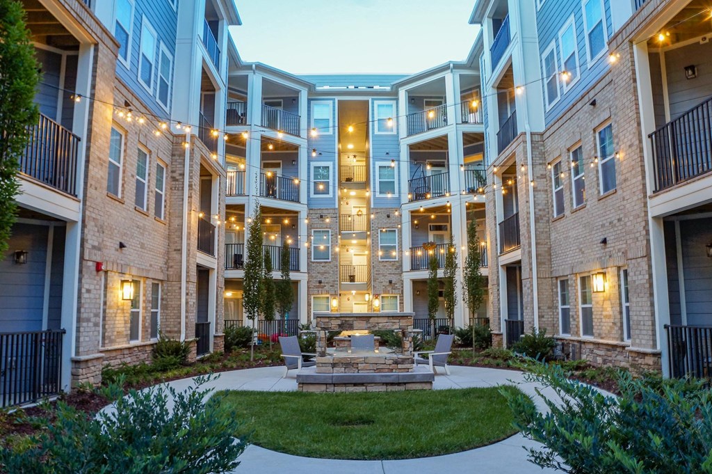 a courtyard with a fountain in the middle of an apartment building