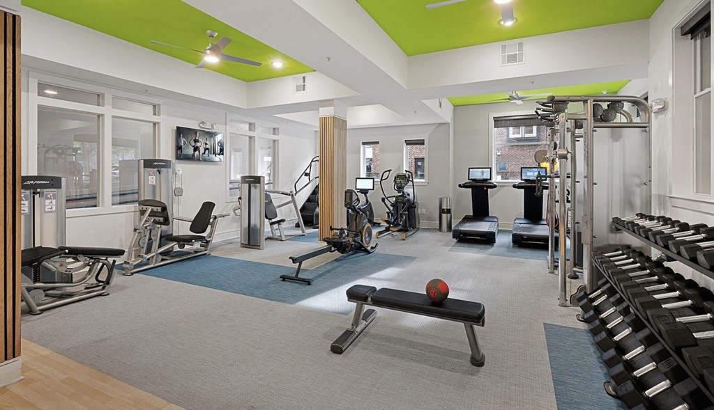 a gym with weights and cardio equipment at the community center