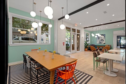 a dining room with a wooden table and chairs