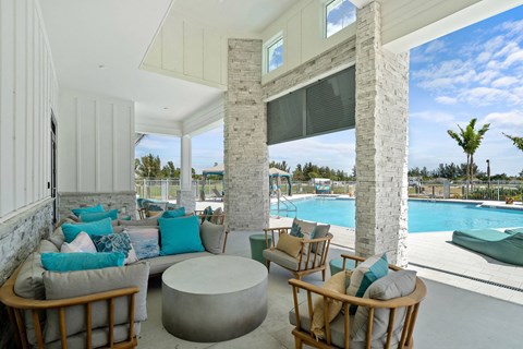 A white room with a pool outside the window.