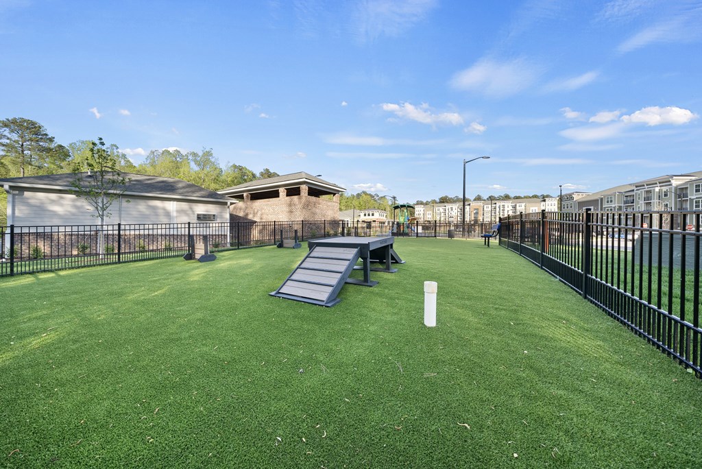A park with a slide and a picnic table.