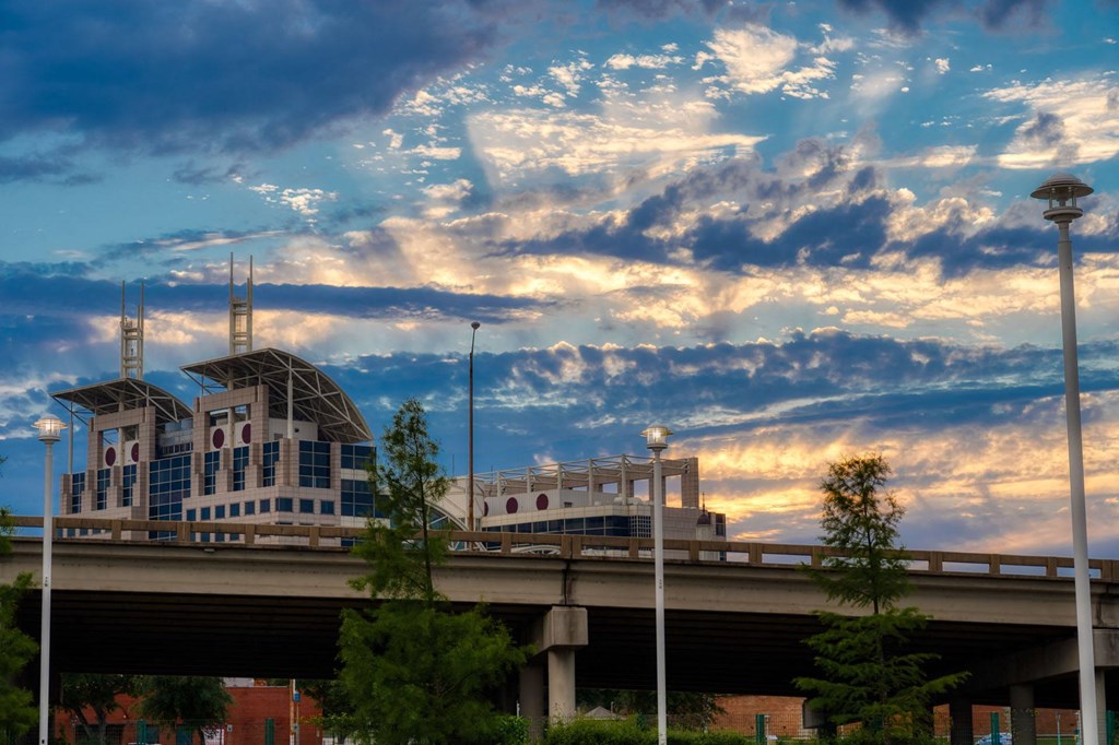 a city at sunset with a bridge and a building