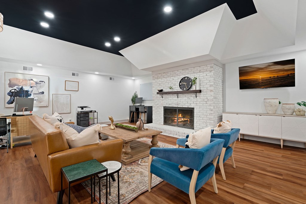 a living room with couches and chairs and a fireplace