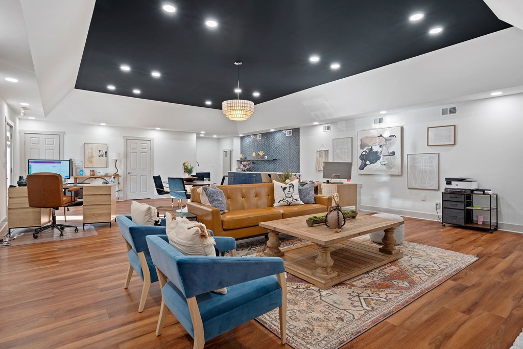 a living room with couches and chairs and a table