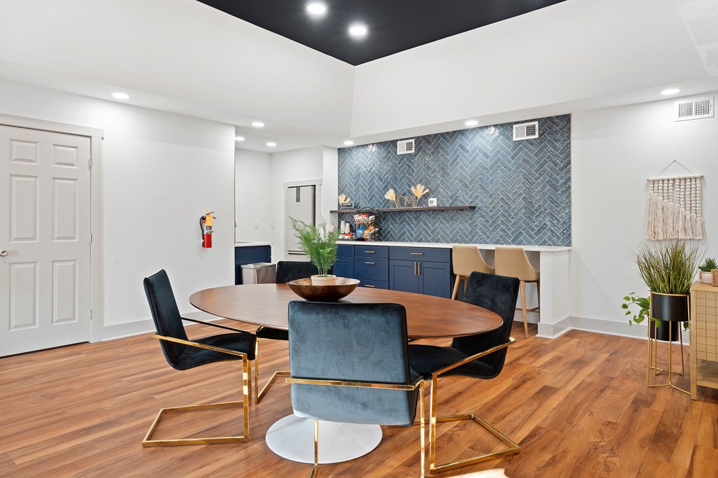 a dining room with a table and chairs and a kitchen