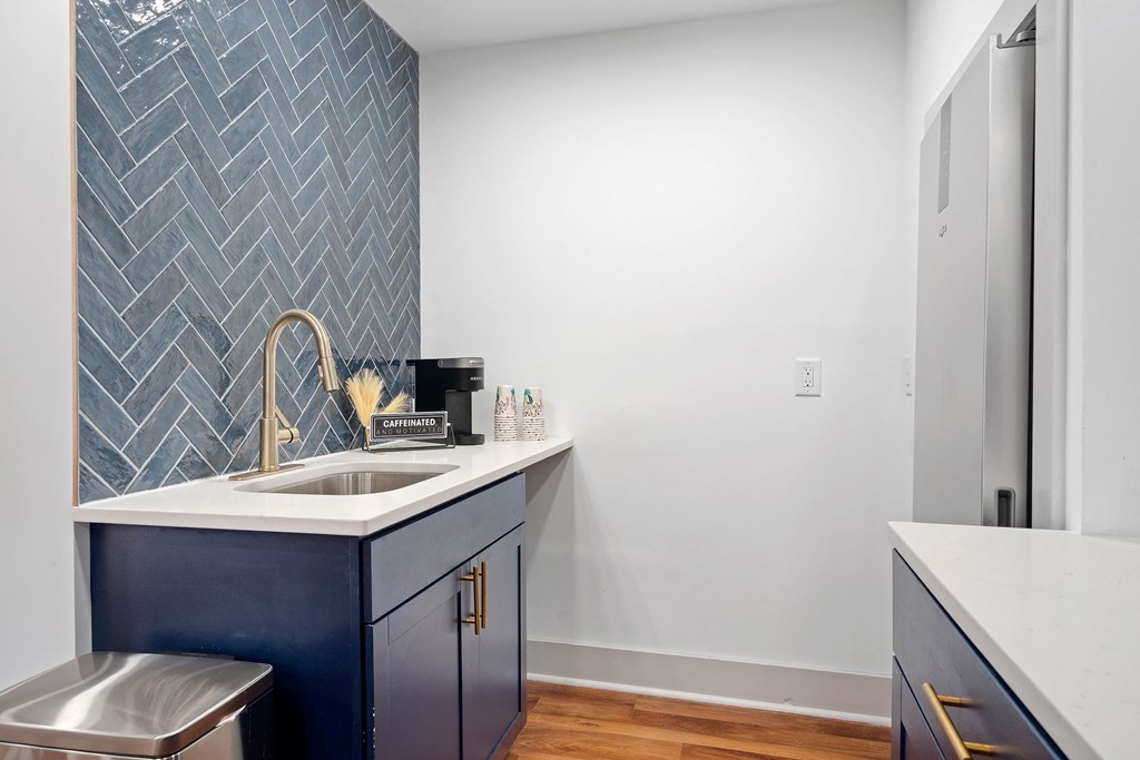 a kitchen with a sink and a blue and white counter top