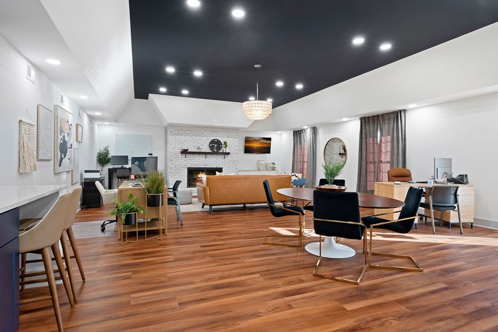a living room with a fireplace and a table and chairs