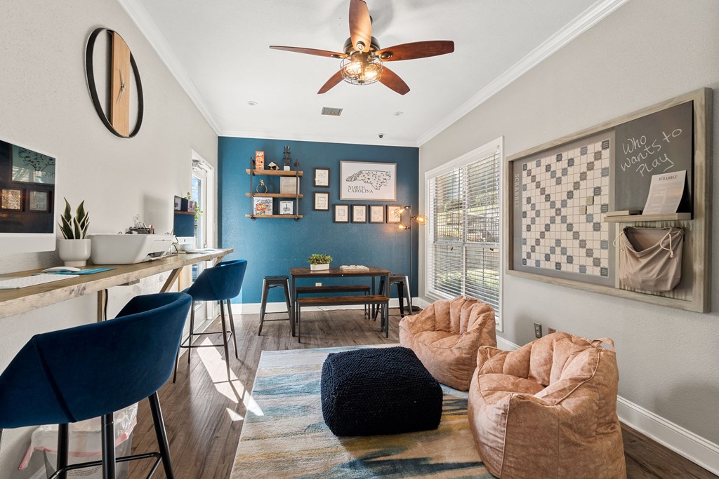 a living room with a ceiling fan and a dining room