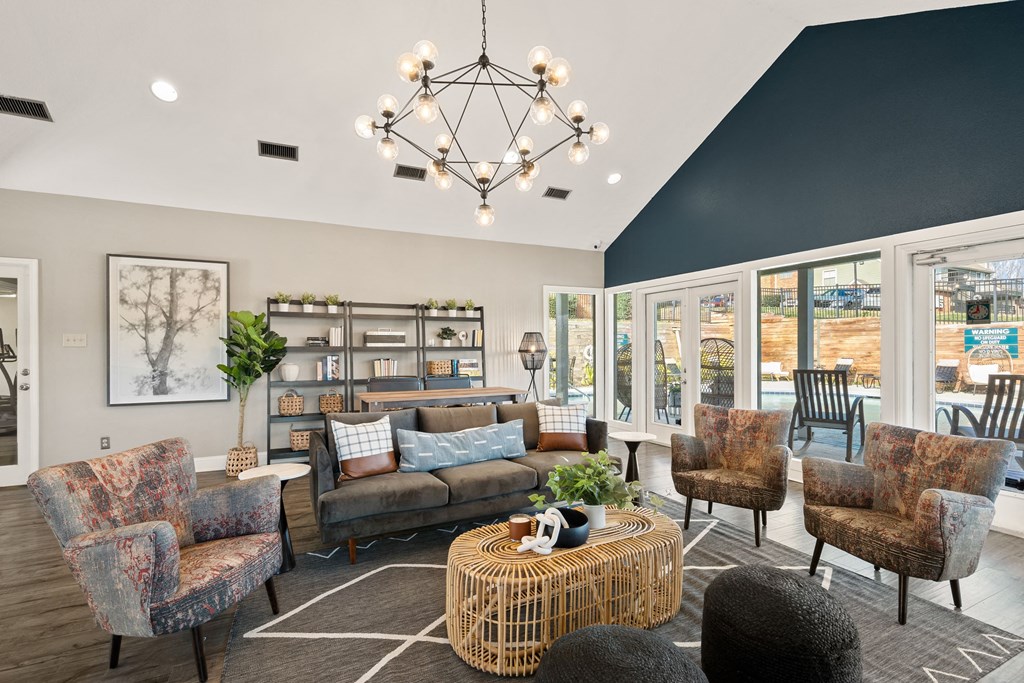 a living room with couches and chairs and a chandelier