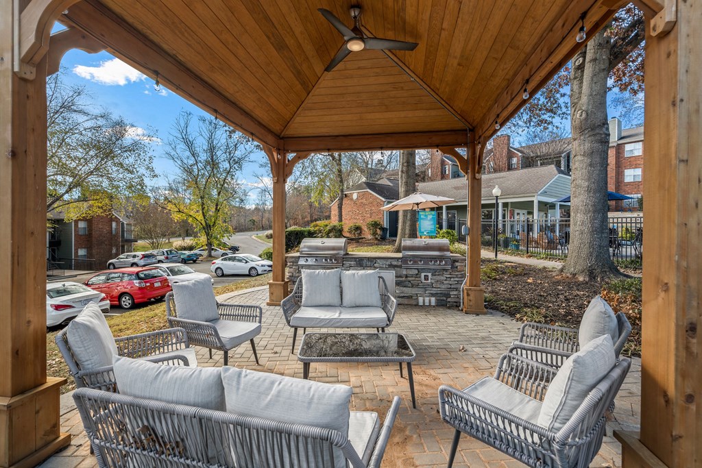 an outdoor patio with chairs and a gazebo