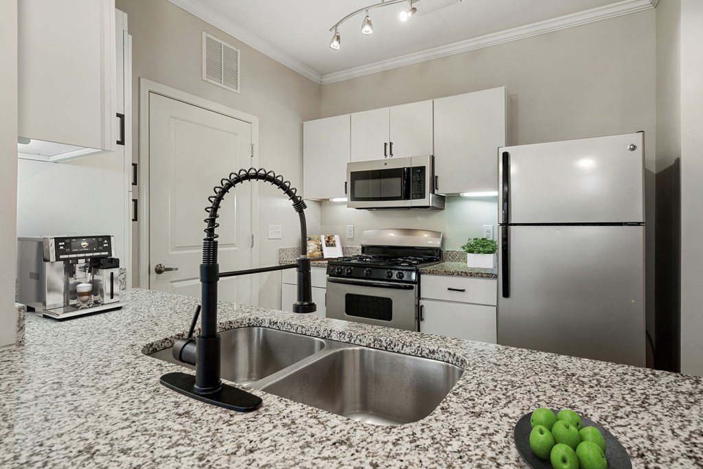 a kitchen with granite counter tops and stainless steel appliances