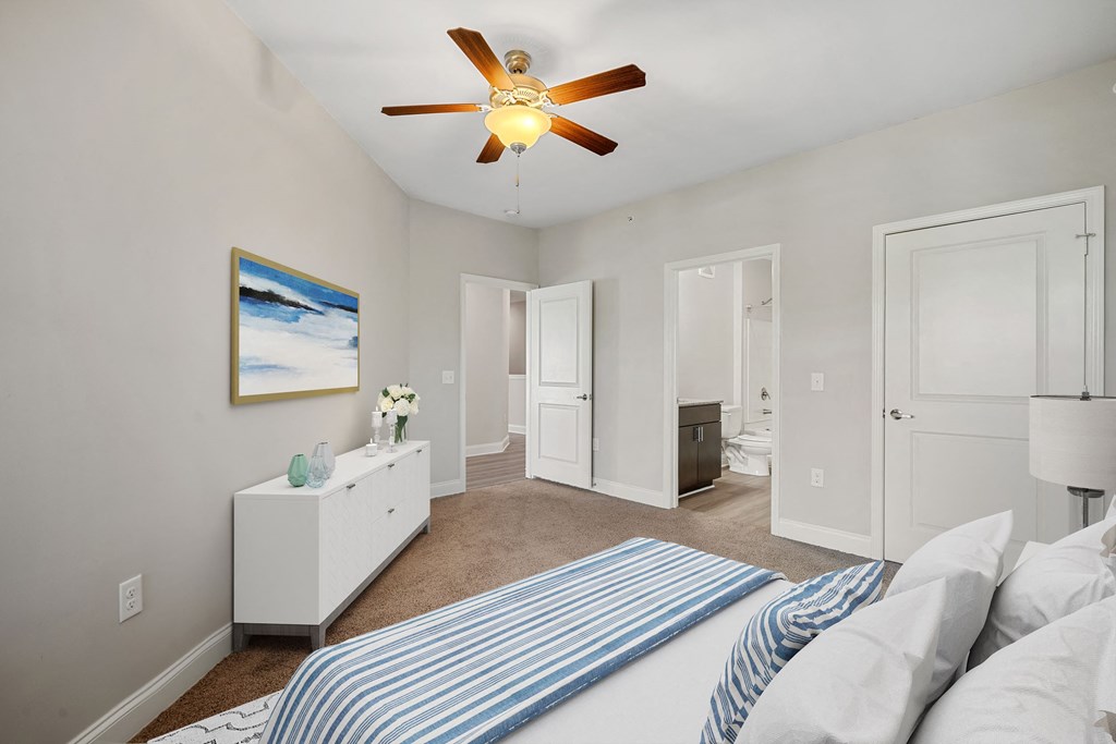 a bedroom with a bed and a ceiling fan