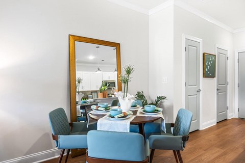A dining room with a table set for four.
