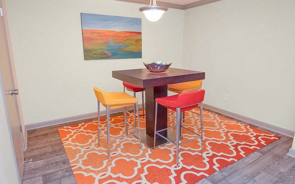 a dining room with a table and two chairs