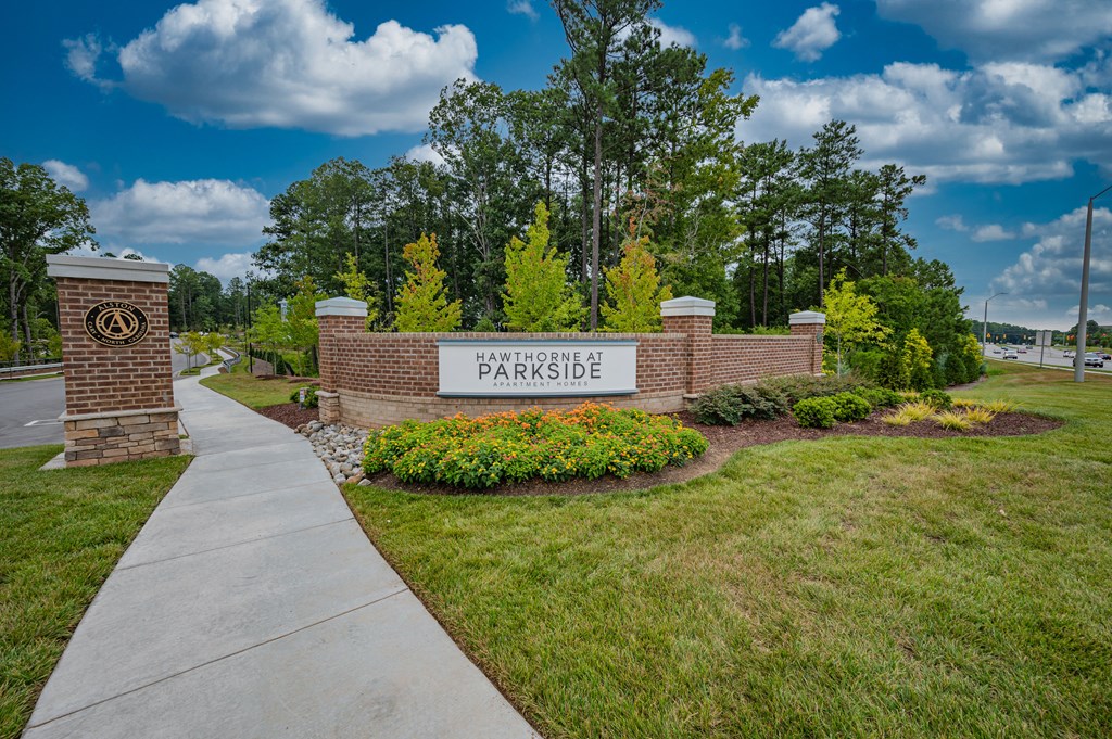 the entrance to parkside with a sign and a sidewalk