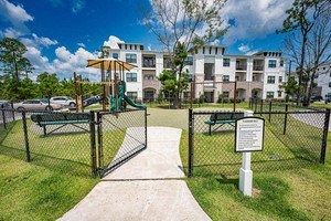 a playground in a park in front of an apartment building