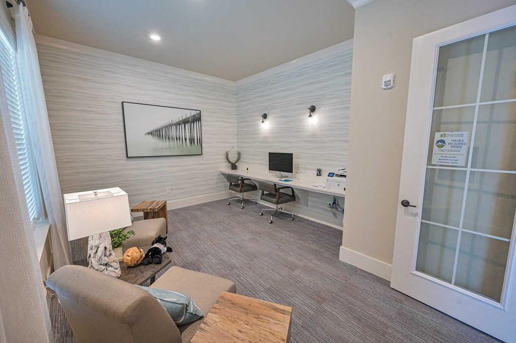 a living room with a couch and a desk with a computer
