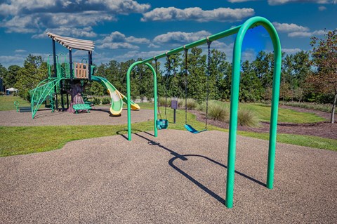 a playground with a swing set and monkey bars